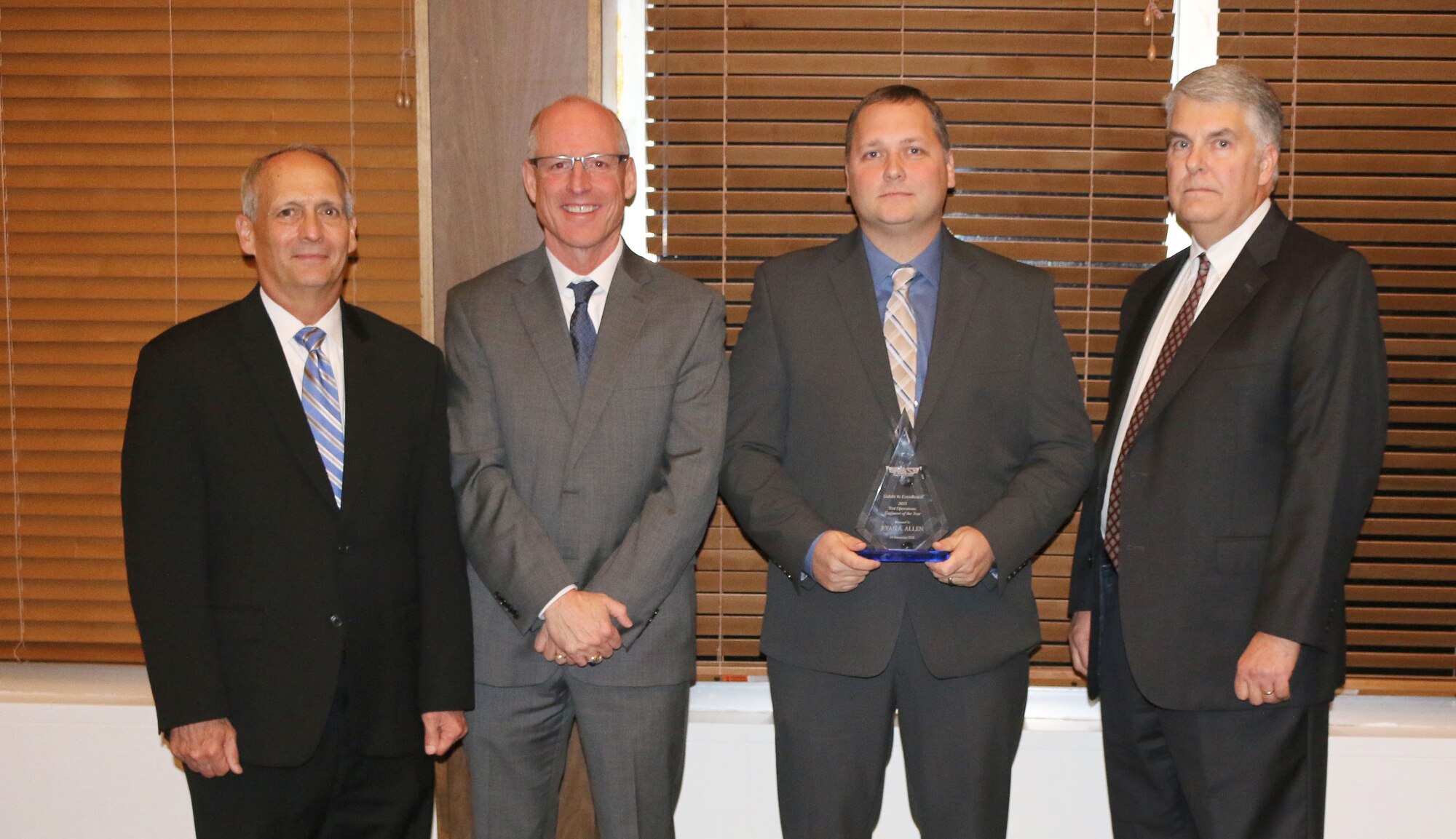 Senior Test Operations Engineer Ryan Allen (third from left) receives the Test Operations Engineer of the Year Award during the National Aerospace Solutions, LLC Salute to Excellence Annual Award Ceremony Nov. 14, 2018, at the Arnold Lakeside Center, Arnold Air Force Base, Tenn. Also pictured from left is NAS Deputy General Manager Michael Belzil, NAS General Manager Richard Tighe and NAS Test and Sustainment Engineering Manager Jeff Henderson. (U.S. Air Force photo by Bradley Hicks)