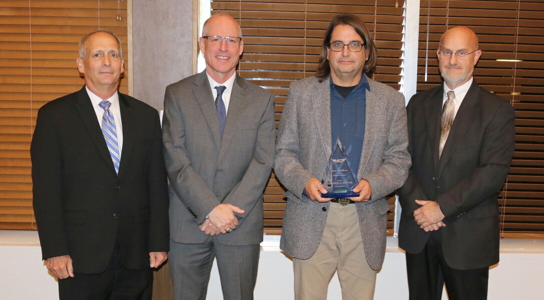 Facility Tech Engineer Jefferson Stewart (third from left) receives the Innovation Award during the National Aerospace Solutions, LLC Salute to Excellence Annual Award Ceremony Nov. 14, 2018, at the Arnold Lakeside Center, Arnold Air Force Base, Tenn. Also pictured from left is NAS Deputy General Manager Michael Belzil, NAS General Manager Richard Tighe and NAS Technology Innovation Branch Manager Mark Brandon. (U.S. Air Force photo by Bradley Hicks)