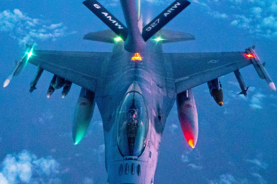 An aircraft  receives fuel from another in the air.