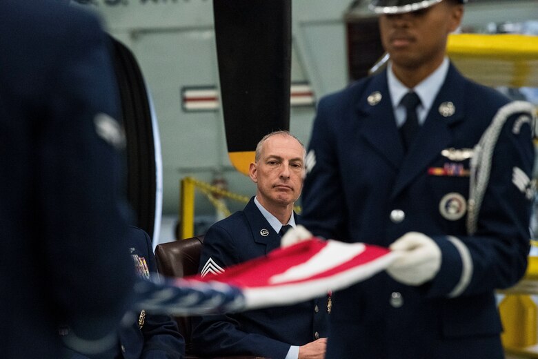 Chief Master Sgt. Larry Williams, Air Mobility Command command chief, Scott Air Force Base, Ill., watches members of the Dover Air Force Base Honor Guard perform a flag folding ceremony during his retirement ceremony Nov. 30, 2018, at the Air Mobility Command Museum on Dover AFB, Del. Brig. Gen. Albert Miller, commander, Defense Logistics Agency, Energy, Ft. Belvoir, Va., was the officiating officer for the ceremony which paid special tribute to Williams' distinguished career spanning over 30 years of dedicated service to the nation. (U.S. Air Force photo by Roland Balik)