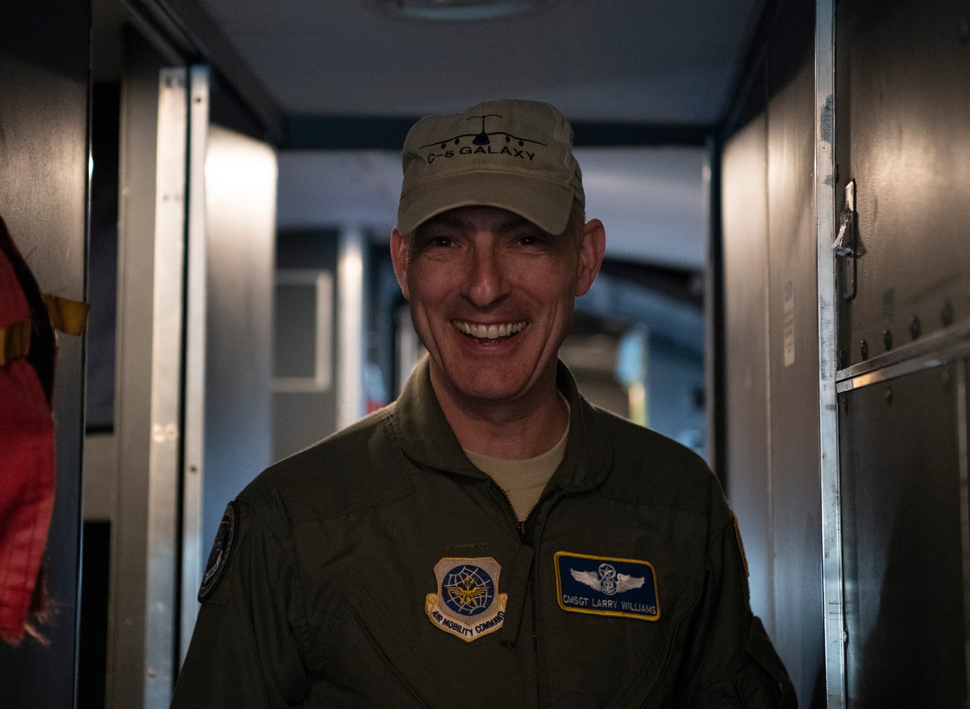 Chief Master Sgt. Larry C. Williams, Air Mobility Command command chief, poses for a photo on the flight deck of a C-5M Super Galaxy prior to his final flight Nov. 29, 2018, at Dover Air Force Base, Del. During the 4-hour flight, the aircrew performed two touch-and-go’s as well as in-flight refueling. After the aircraft was parked, Williams received the traditional hose-down from family, friends and base personnel. (U.S. Air Force photo by Airman 1st Class Zoe M. Wockenfuss)