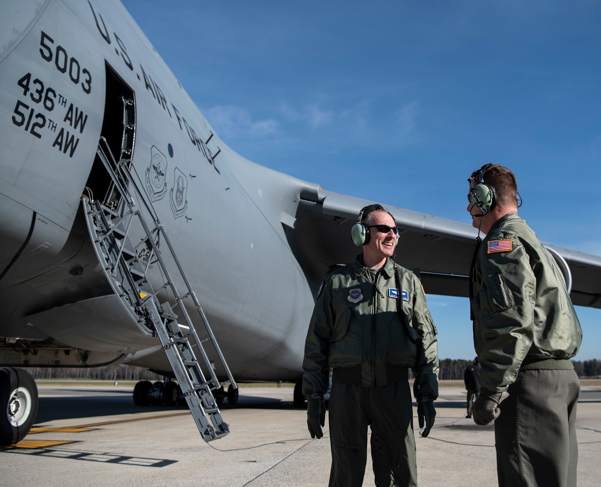 Chief Master Sgt. Larry C. Williams, Air Mobility Command command chief, speaks with Chief Master Sgt. Stephen West, 709th Airlift Squadron chief flight engineer, prior to takeoff on his final flight in a C-5M Super Galaxy Nov. 29, 2018, at Dover Air Force Base, Del. During the flight, the aircrew performed two touch-and-go’s as well as  in-flight refueling with the 916th Air Refueling Wing, Air Force Reserve Command, Seymour Johnson Air Force Base, N.C. (U.S. Air Force photo by Airman 1st Class Zoe M. Wockenfuss)