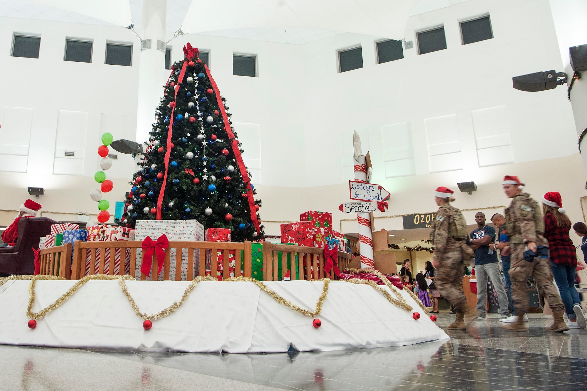 Service members and military families attend a holiday kick-off event Dec. 1, 2018, at Al Udeid Air Base, Qatar. Attendees were able to play holiday games, watch live music performances, and interact with Santa Claus during the event. (U.S. Air Force photo by Tech. Sgt. Christopher Hubenthal)