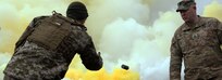 Sgt. 1st Class Conrad Martin [right], an Observer/Coach Trainer with the Joint Multinational Readiness Center observes a Ukrainian soldier as he throws a smoke grenade during preparation for exercise Combined Resolve XI Dec. 1 at Hohenfels Training Area, Germany.