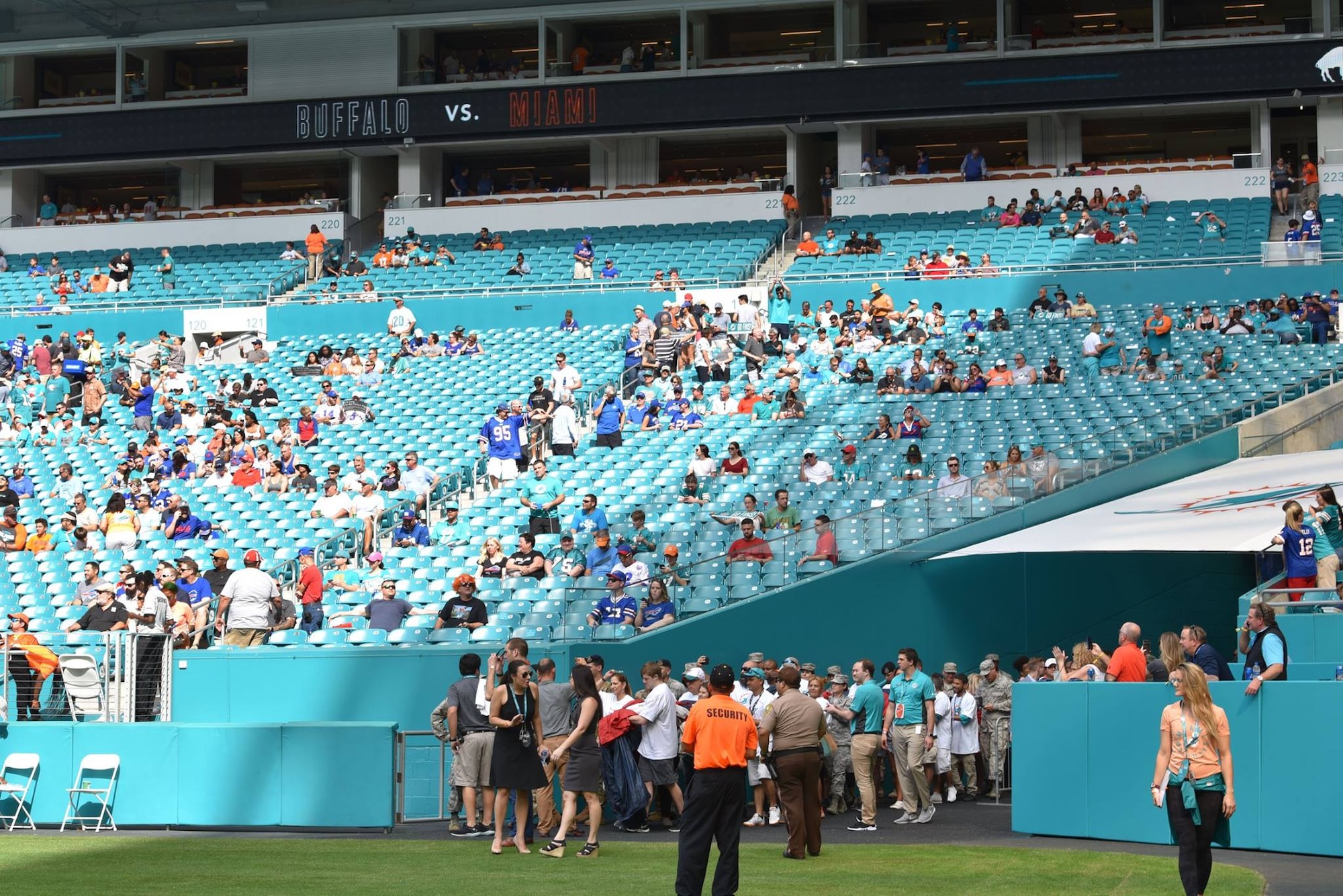 Airmen and local community members unfurl the flag for the National Anthem prior to the start of a Miami Dolphins football game on Dec 2, 2018 in Miami. Approximately 75 Airmen from Patrick Air Force Base, Fla. participated in the event. (U.S. Air Force photo by Tech. Sgt. Andrew Satran)