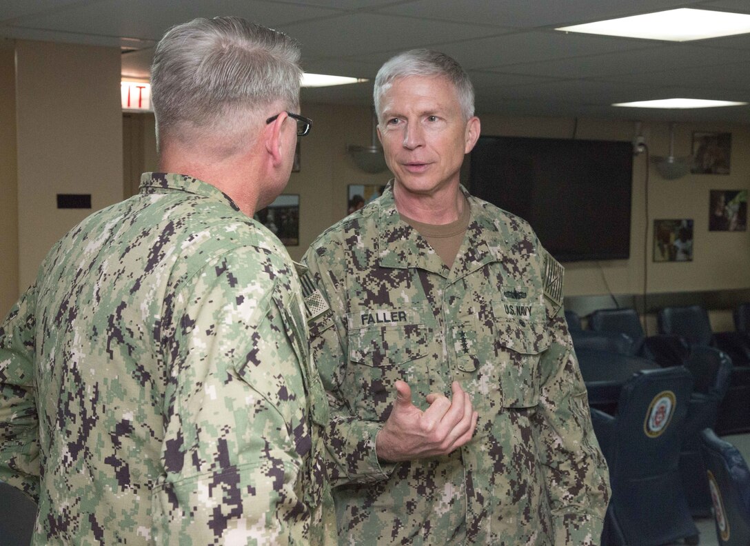Adm. Craig Faller, commander, U.S. Southern Command (Center), and U.S. Navy Capt. William Shafley, commander, Task Force 49, exchange words aboard the hospital ship USNS Comfort (T-AH 20) during his visit to Colombia.