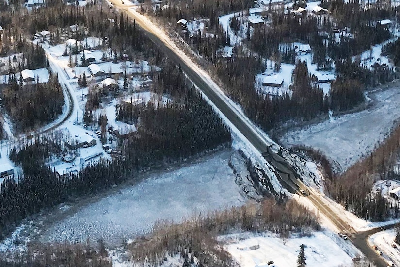An aerial photo shows a damaged bridge in Alaska.