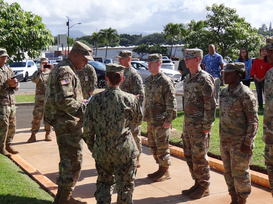 Navy Cmdr. Shani LeBlanc, DLA Troop Support Pacific commander, prepares to present Certificates of Achievement awards to five Soldiers for their contributions to RIMPACT 2018, Nov. 21, 2018 at Joint Base Pearl Harbor-Hickman, Hawaii. RIMPACT is the world's largest international maritime exercise that takes place in the Hawaiian Islands every two years.