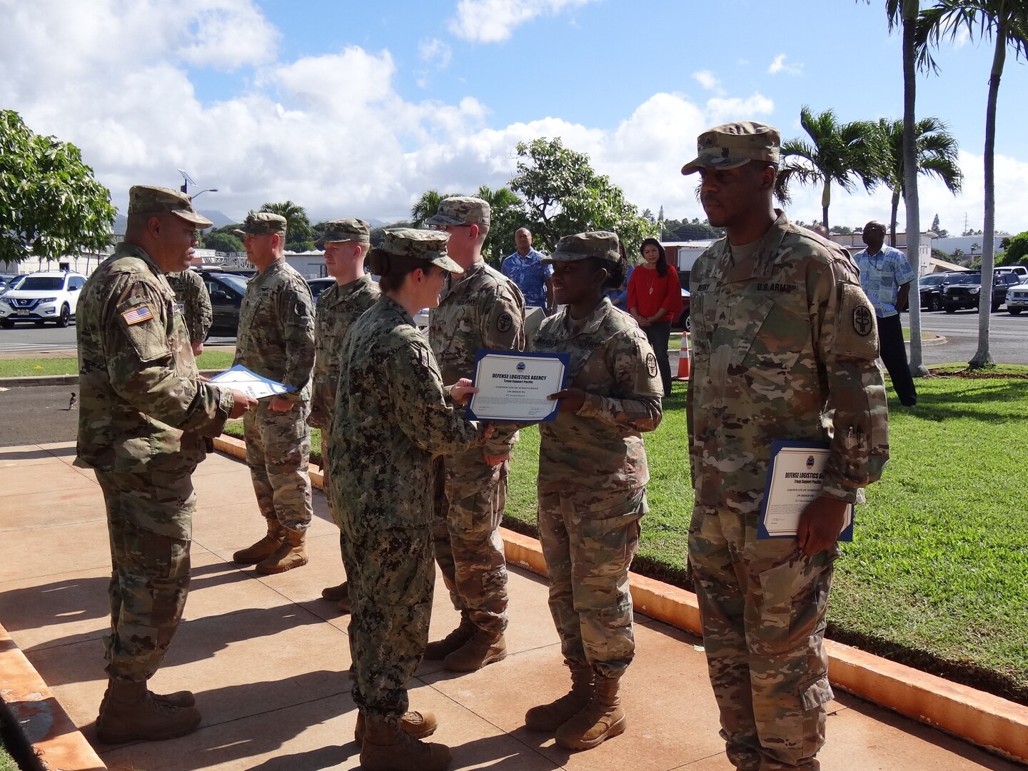 Navy Cmdr. Shani LeBlanc, DLA Troop Support Pacific commander, present a Certificate of Achievement awards to Army Spc. Jazzmon Brunson, a food safety inspector, for her contributions during RIMPACT 2018, Nov. 21, 2018 at Joint Base Pearl Harbor-Hickman, Hawaii. RIMPACT is the world's largest international maritime exercise that takes place in the Hawaiian Islands every two years.