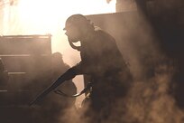World War I reenactor moves through trenches