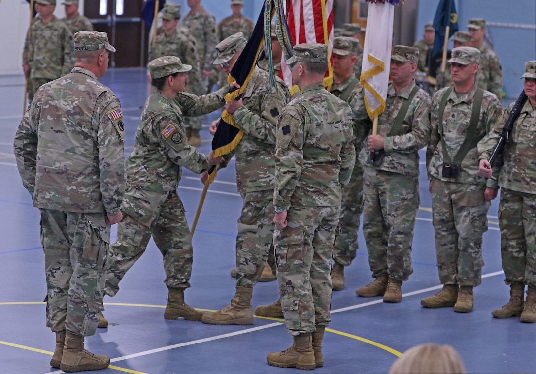 Maj. Gen. Jody J. Daniels, commanding general, 88th Readiness Division passes the unit colors to Command Sgt. Maj.  Jeffrey L. McGlin, senior enlisted advisor, 88th Readiness Division, entrusting the unit's safe keeping under arms, during the 88th Readiness Division change of command ceremony Dec. 1, 2018, at Fort McCoy, Wisconsin. The transfer of the colors from one commander to another is a symbolic transfer of command authority and responsibility from one commander to another.