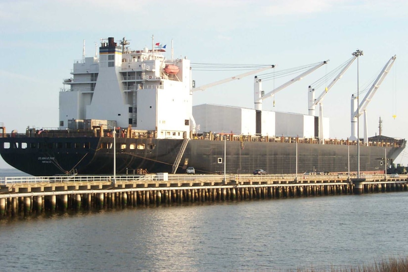 A large ship sits at a dock.