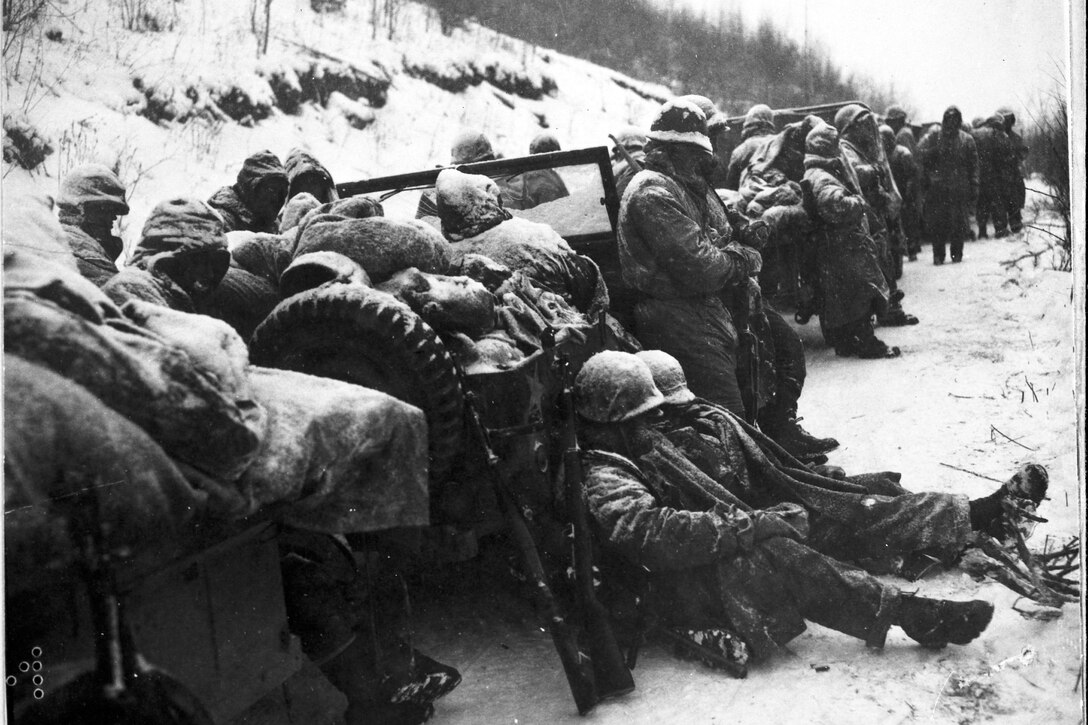 A black and white photo of Marines in the snow.