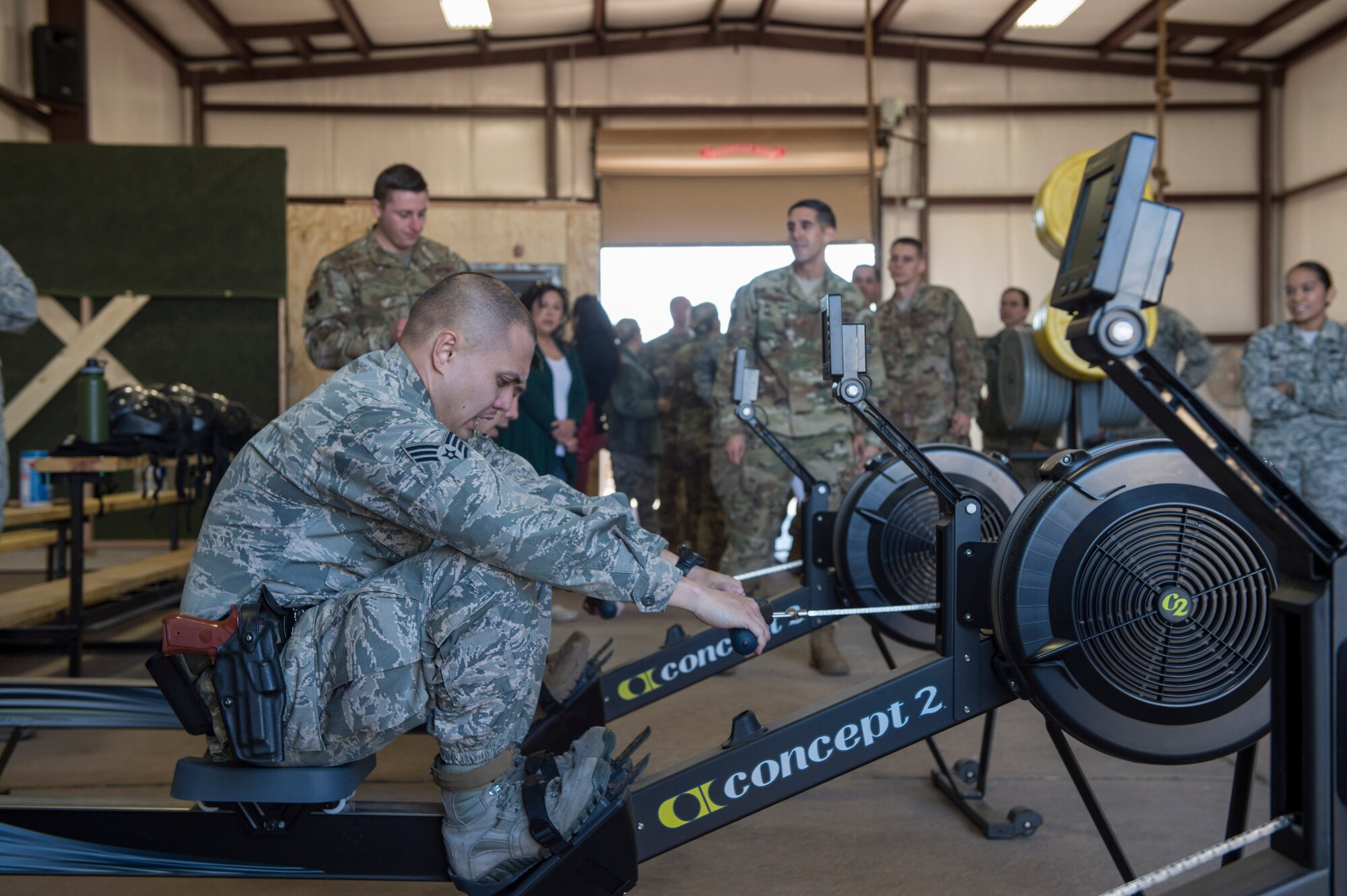Members of the 97th Security Forces Squadron staff support team utilize rowing machines