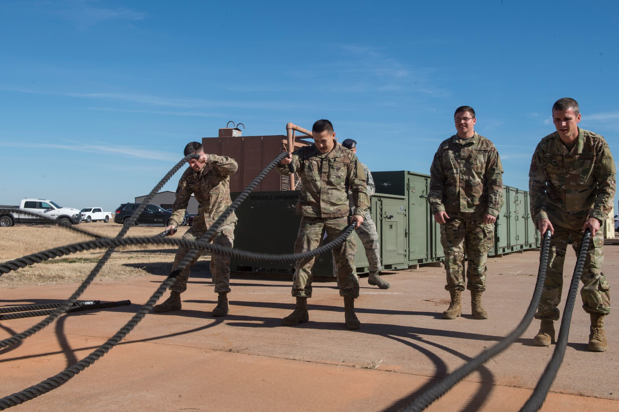 Members of the 97th Logistics Readiness Squadron swing ropes