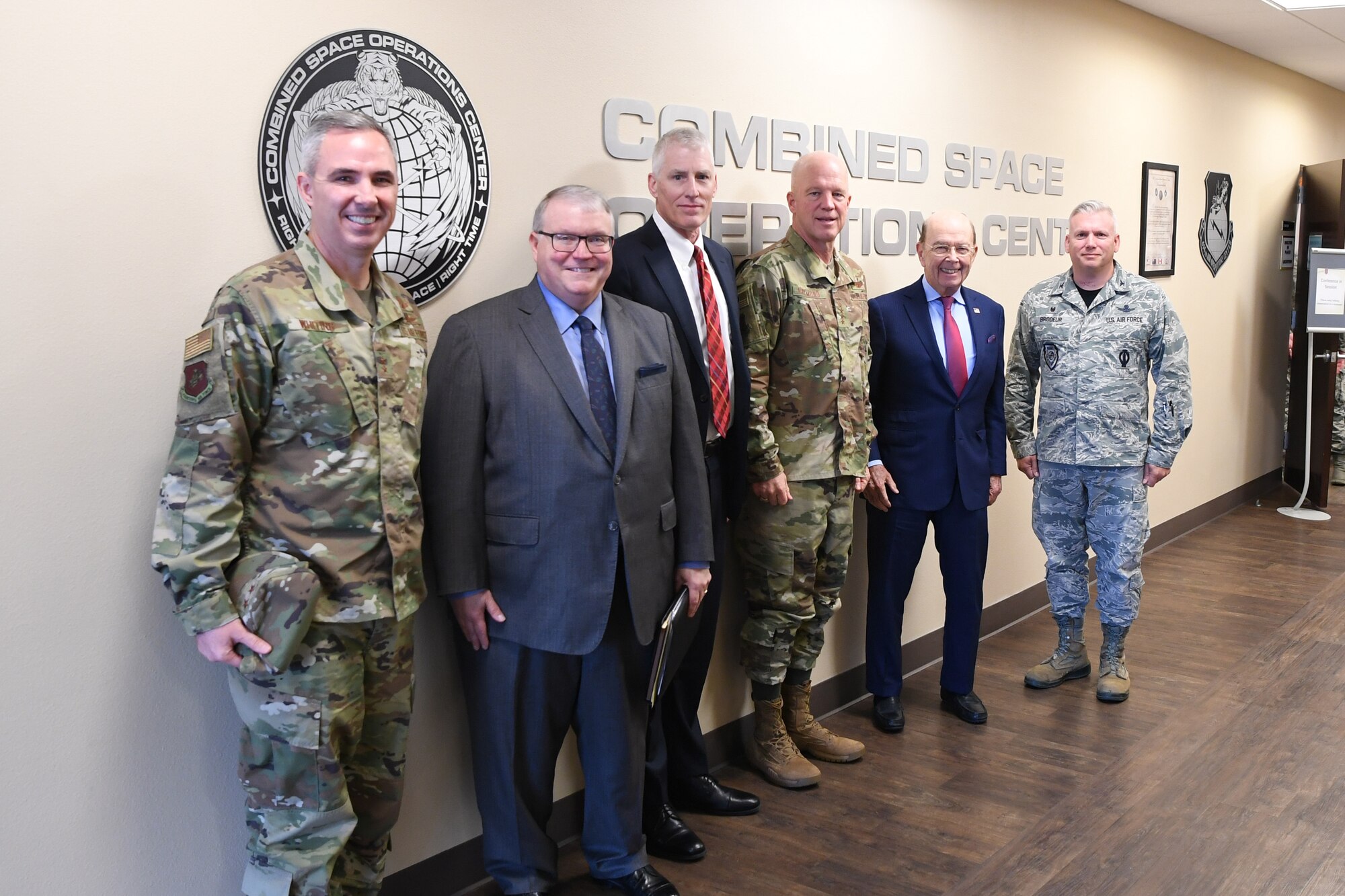 U.S. Secretary of Commerce Wilbur Ross (second from right) poses for a photo with Department of Commerce and Joint Force Space Component Command leaders in the Combined Space Operations Center at Vandenberg AFB, Calif., Nov. 30, 2018. Secretary Ross met with service members from the 18th Space Control Squadron, Combined Space Operations Center, Joint Force Space Component Command and U.S. Strategic Command to discuss Space Situational Awareness capabilities and space operations during a visit here Nov. 29-30. Secretary Ross also spoke with service members about the Department of Defense transitioning non-military aspects of Space Situational Awareness and space safety monitoring and responsibilities to the Department of Commerce. (U.S. Air Force photo by Maj. Cody Chiles)