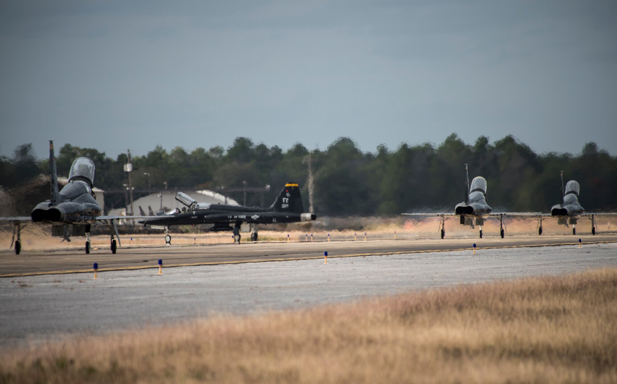 A formation of T-38 Talons fly in formation over the runway Nov. 30 at Eglin Air Force Base, Fla. Seven Talons arrived here, their temporary home as part of a mission shift by the Air Force as Hurricane Michael recovery efforts continue at Tyndall. The 2nd FS is one of two T-38 Talon adversary squadrons. They provide air-to-air threat replication to support F-22 Raptor combat and formal training squadrons. The squadron also maintains readiness to augment worldwide combat operations.