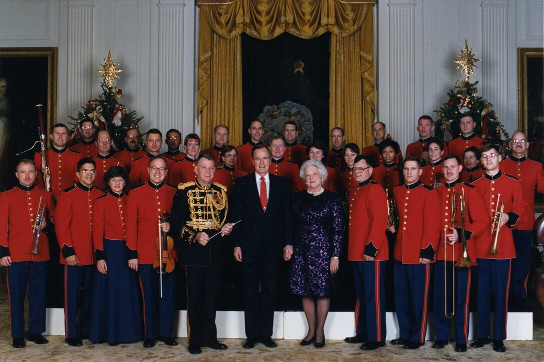 President George H.W. Bush and Mrs. Barbara Bush, with Col. John Bourgeois and members of the Marine Chamber Orchestra at a holiday reception on Dec. 12, 1990. (official White House photo)