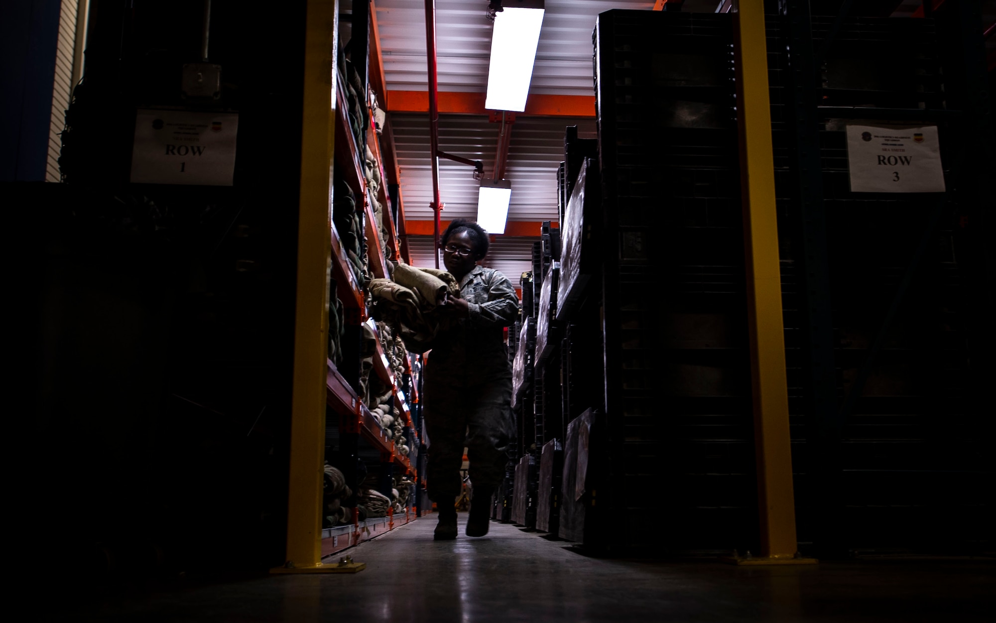 U.S. Air Force Senior Airman Shanice Smith, 20th Logistics Readiness Squadron individual protective equipment journeyman, carries mission oriented protective posture gear at Shaw Air Force Base, S.C., Nov. 30, 2018.