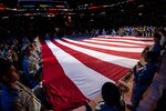 Members of the 59th Medical Wing, Joint Base San Antonio-Lackland, participate in the Living Flag ceremony held before the Dec. 2 game between the San Antonio Spurs and Portland Trailblazers at the AT&T Center in San Antonio, Texas. Nearly 30 Airmen held the flag aloft during the singing of the national anthem. 
(Photo courtesy of the San Antonio Spurs)