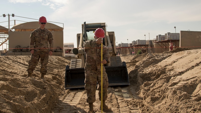 A U.S. Army Soldier with the 526th Engineer Construction Company, 92nd Engineer Battalion, 28th Engineer Brigade, measures the depth of a trapezoidal ditch being dug at Camp Arifjan, Kuwait, Nov. 28, 2018. U.S. Army Capt. Bryan Thompson, the commander of the 526th ECC, said, “The one thing I really want to highlight is, I'm really blessed to have such a great team.” The Soldiers of the 526th ECC conducted constant operations to immediately resolve flooding earlier in the month, and continue to improve drainage features at Camp Arifjan with projects like this ditch.