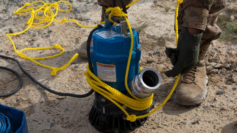 U.S. Army Pfc. Donnesha Streetman, a multi-systems transmission maintainer and operator with U.S. Army Network Enterprise Center-Kuwait, prepares a pump to remove water from an access service point at Camp Buehring, Kuwait, Dec. 1, 2018. Keeping communication lines operational during extreme weather events is an essential task to ensure our personnel remain capable to accomplish their mission.