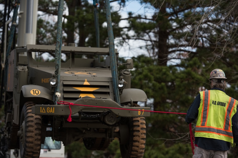 Ruben Golderos, contractor, guides a M16 Multiple Gun Motor Carriage Half-track as it is lowered onto a flat car at the U.S. Army Transportation Museum at Joint Base Langley-Eustis, Virginia, Dec. 3, 2018.