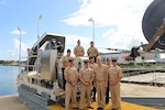Rear Adm. John Neagley, Program Executive Officer for Unmanned and Small Combatants, poses with sailors attached to USS Forth Worth (LCS 3) at a test event for the DART mission system at the Harbor Branch Oceanographic
Institute in Fort Pierce, Florida.