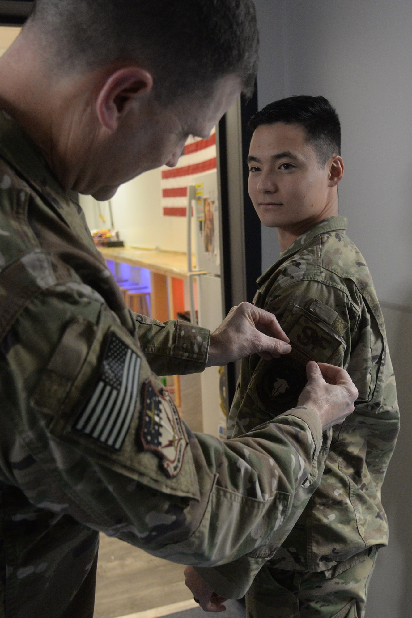 Second Lt. Kojiro Kobayashi, 841st Missile Security Forces Squadron flight commander, receives his raven patch from Col. Aaron Guill, 341st Security Forces Group commander Nov. 7, 2018, at Malmstrom Air Force Base, Mont. Upon graduation, Kobayashi became the 2729th raven since the implementation of the phoenix raven program in 1997. (U.S. Air Force photo by Airman 1st Class Tristan Truesdell)