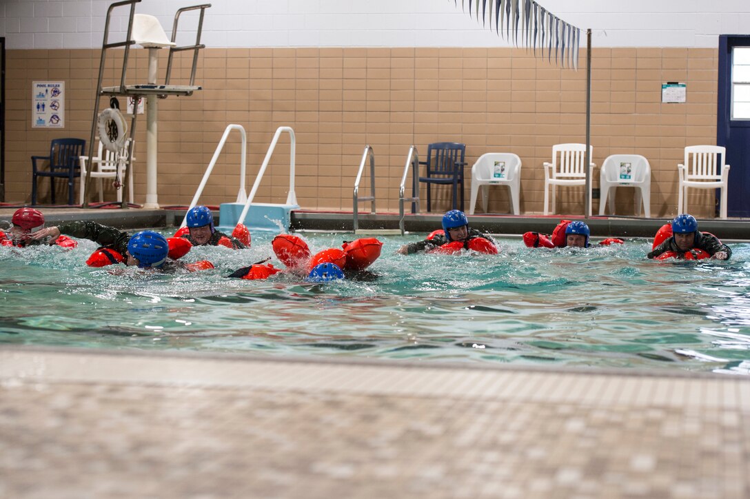 U.S. Air Force members practice different swimming techniques
