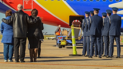 The Joint Base Charleston honor guard flight stands at attention as an Airman’s casket is brought off a plane during a dignified arrival Nov. 28, 2018, at Joint Base Charleston, S.C.