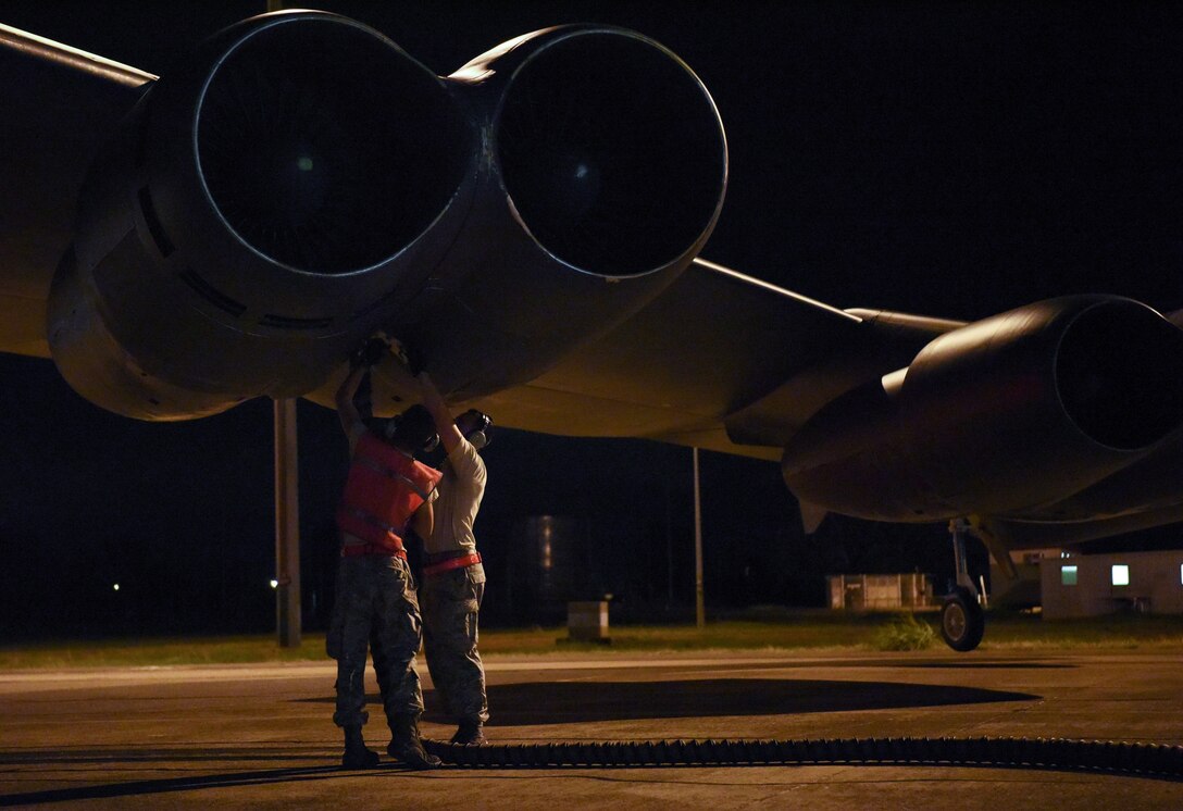 Airman 1st Class Nicholas Casillas and Staff Sgt. Kenny Oliver, crew chiefs from the 96th Expeditionary Bomb Squadron, prepare a U.S. Air Force B-52 Stratofortress for take off at Royal Australian Air Force (RAAF) Base Darwin, Australia, Dec. 3, 2018.