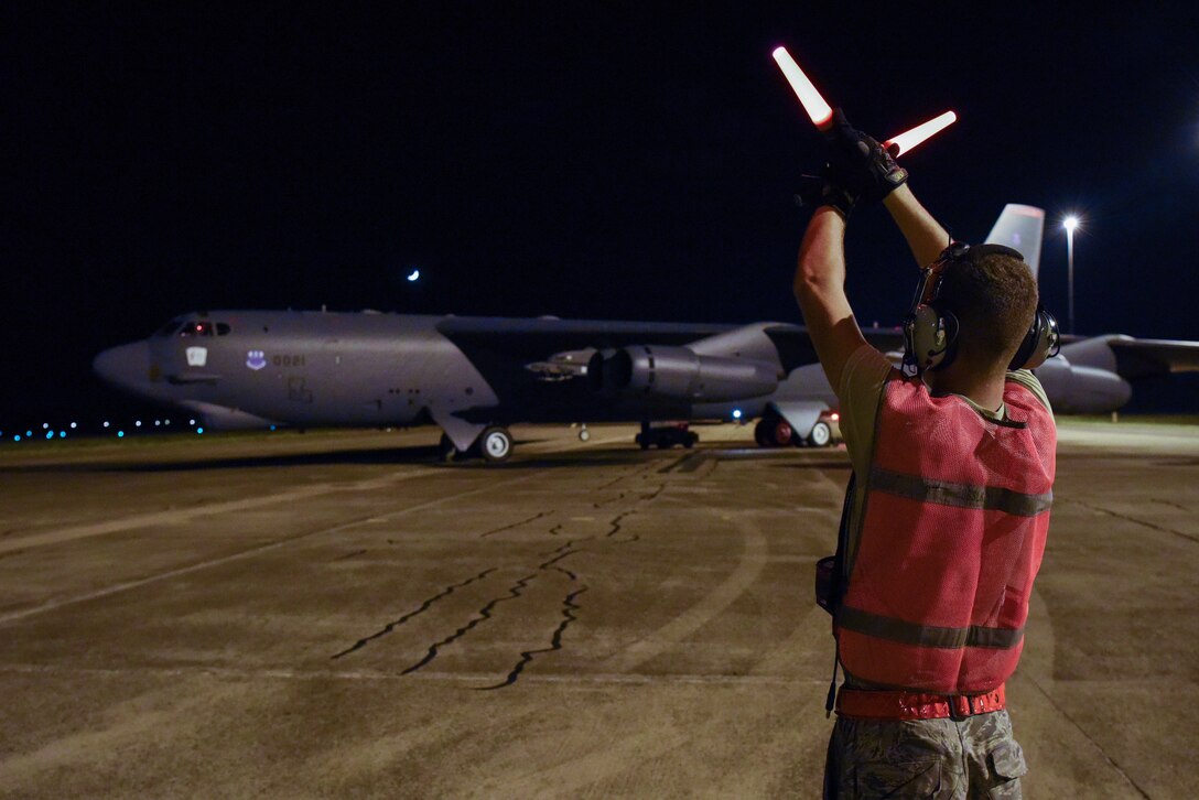 Airman 1st Class Nicholas Casillas, 96th Expeditionary Bomb Squadron crew chief, marshals a U.S. Air Force B-52 Stratofortress before take off at Royal Australian Air Force (RAAF) Base Darwin, Australia, Dec. 3, 2018.