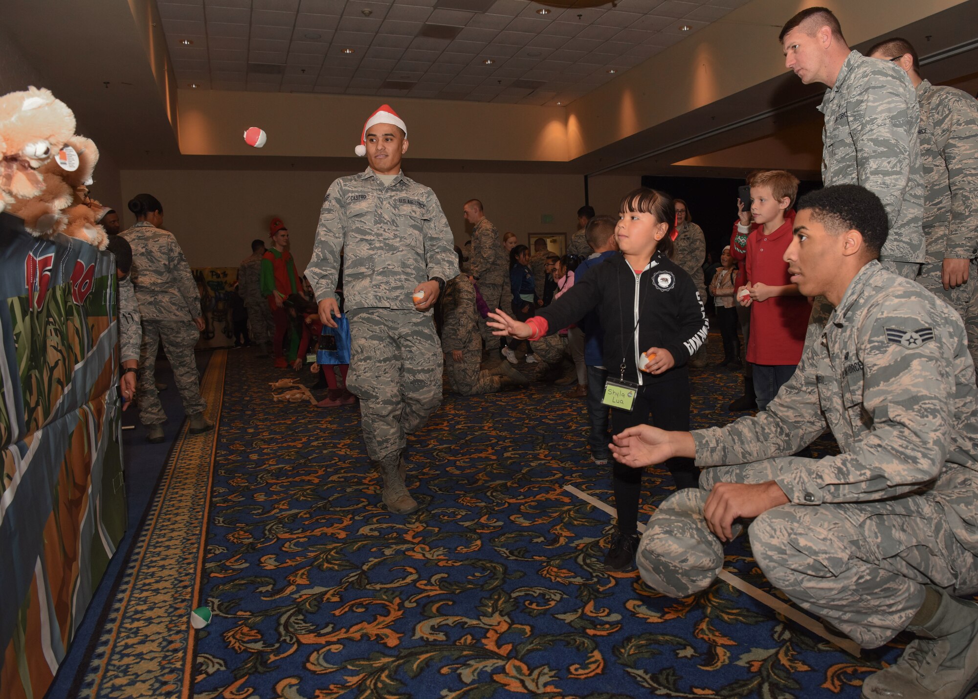 Vandenberg Airmen watch and assist children playing at Operation Kids Christmas at Vandenberg Air Force Base, Calif. Dec. 1, 2018 Vandenberg hosts the 59th annual Operation Kids Christmas here, expecting 200 kids from nearby cities to partake in the planned games, crafts, lunch and Christmas gifts.