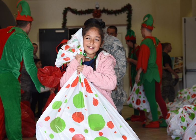 A child receives her gifts after participating in activities for Operation Kids Christmas at the Pacific Coast Club at Vandenberg Air Force Base, Calif. Dec. 1, 2018. Vandenberg hosts the 59th annual Operation Kids Christmas here, expecting 200 kids from nearby cities to partake in the planned games, crafts, lunch and Christmas gifts.