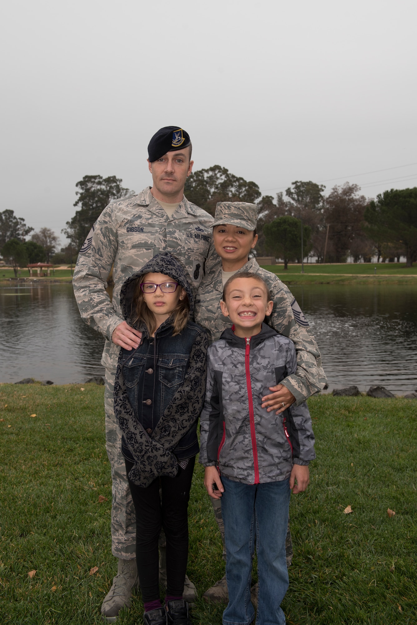 U.S. Air Force Master Sgt. Mike Gibson, left, 60th Security Forces Squadron NCO in charge of operations, and his wife, Master Sgt. Angela Gibson, 60th Surgical Operations Squadron flight chief of anesthesia, pose with their children, Taylor and Carter at Travis Air Force Base, Calif., Nov. 27, 2018. The Gibsons have been a dual military couple for more than a decade. (U.S. Air Force photo by Tech. Sgt. James Hodgman)