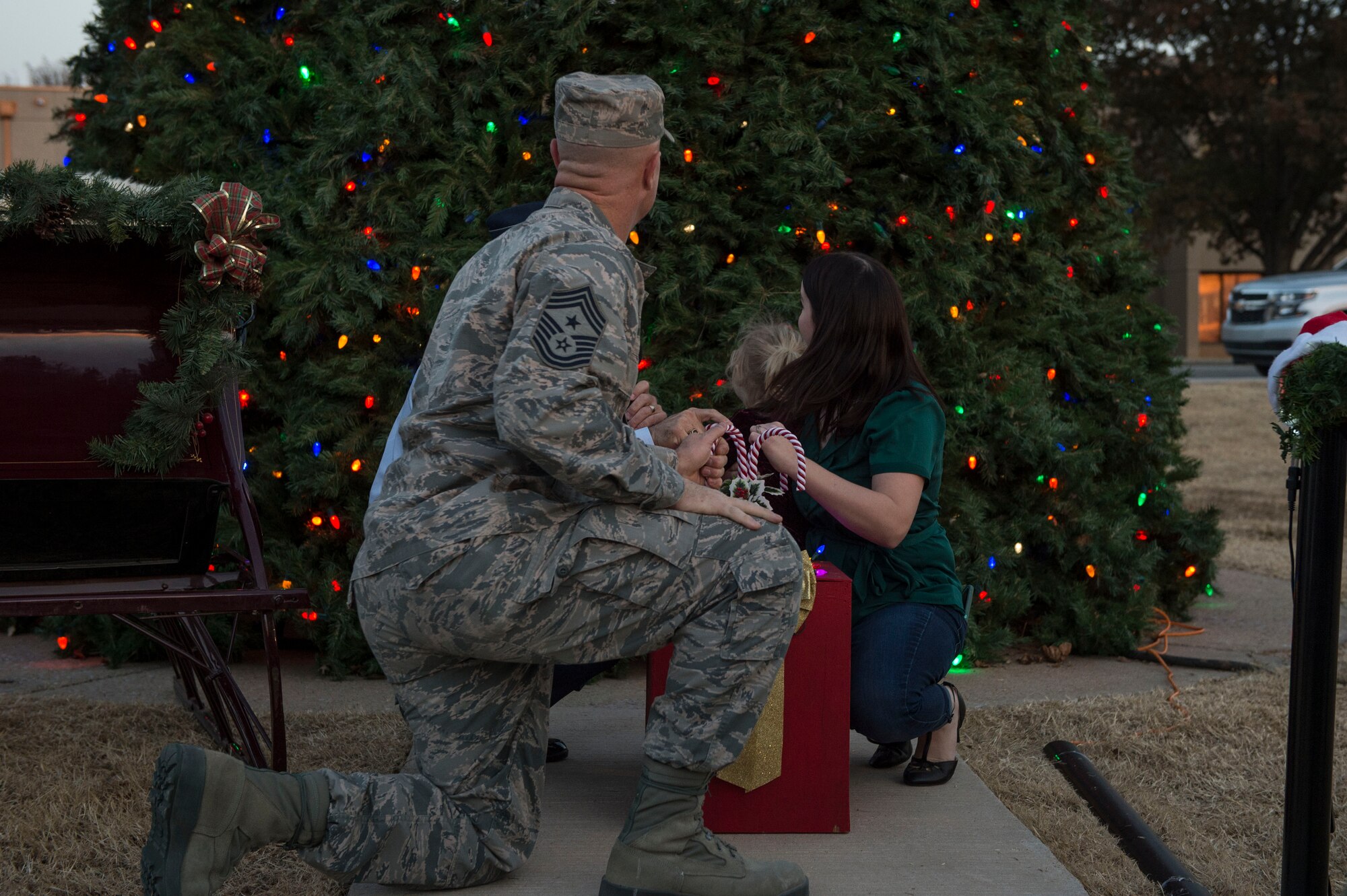 97th Air Mobility Wing leadership and Sami Chase, spouse of U.S. Air Force Senior Airman Austin Chase, an emergency management journeyman assigned to the 97th Civil Engineer Squadron, light the holiday tree as part of the annual Holiday Tree Lighting event, Nov. 29, 2018, at Altus Air Force Base, Okla. Every year during the event a deployed member’s spouse joins the commander and command chief to light the holiday tree to honor all deployed members and their families. (U.S. Air Force photo by Senior Airman Cody Dowell)