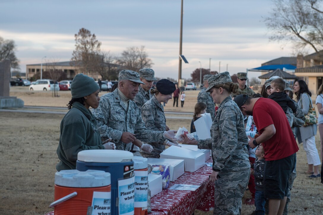 Members of the 97th Air Mobility Wing partake in festivities at the annual holiday tree lighting event, Nov. 29, 2018, at Altus Air Force Base, Okla. The event is hosted by the 97th Force Support Squadron in order to bring members of the military community together during the holidays. (U.S. Air Force photo by Senior Airman Cody Dowell)