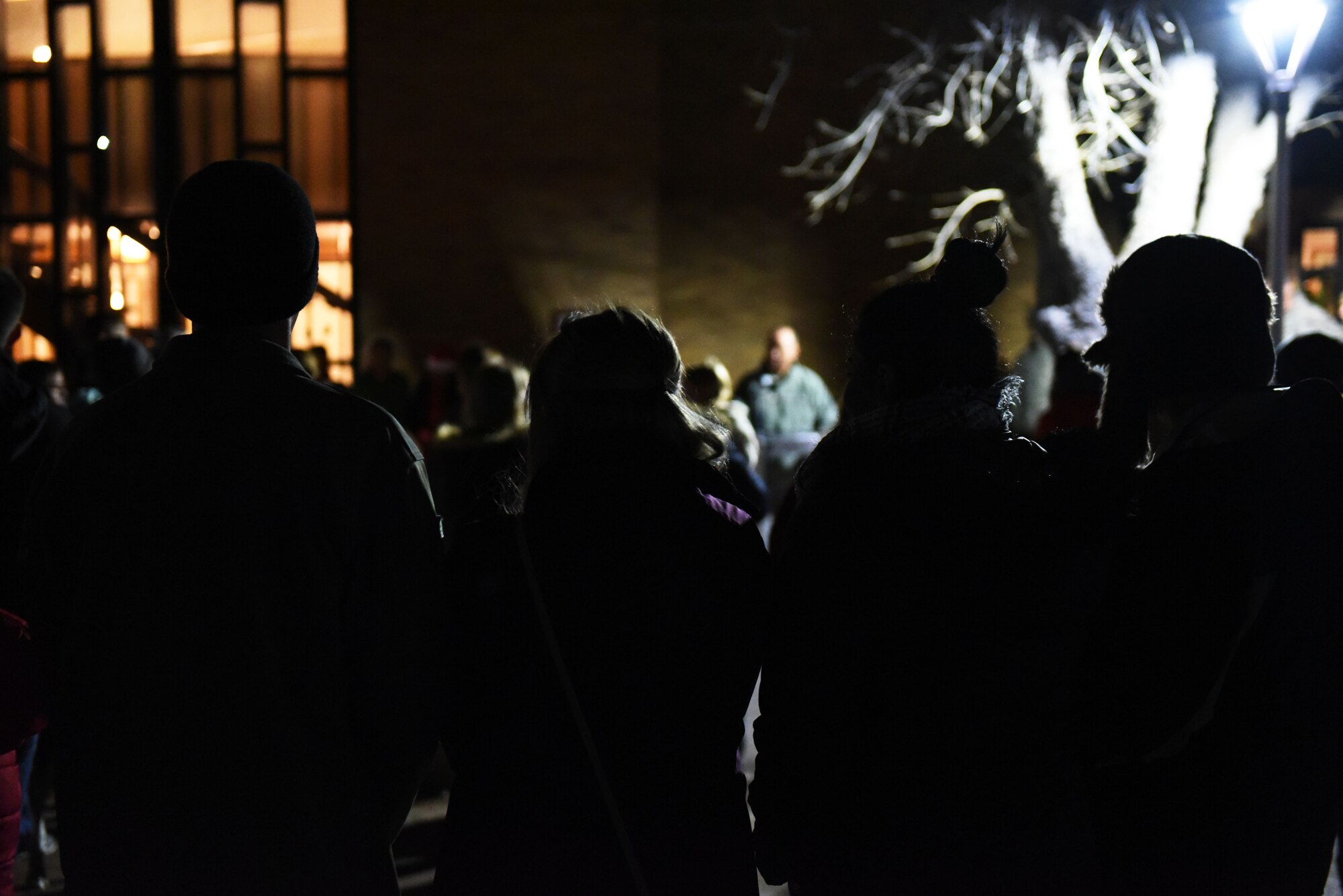 Airmen and their families listen to a speech during the tree lighting ceremony at the Freedom Chapel on Ellsworth Air Force Base, S.D., Nov. 30, 2018. Airmen and their families came out to celebrate the lighting of the base tree and to start the holidays in a festive and family-friendly environment where multiple religions were represented. (U.S. Air Force photo by Airman 1st Class Thomas Karol)
