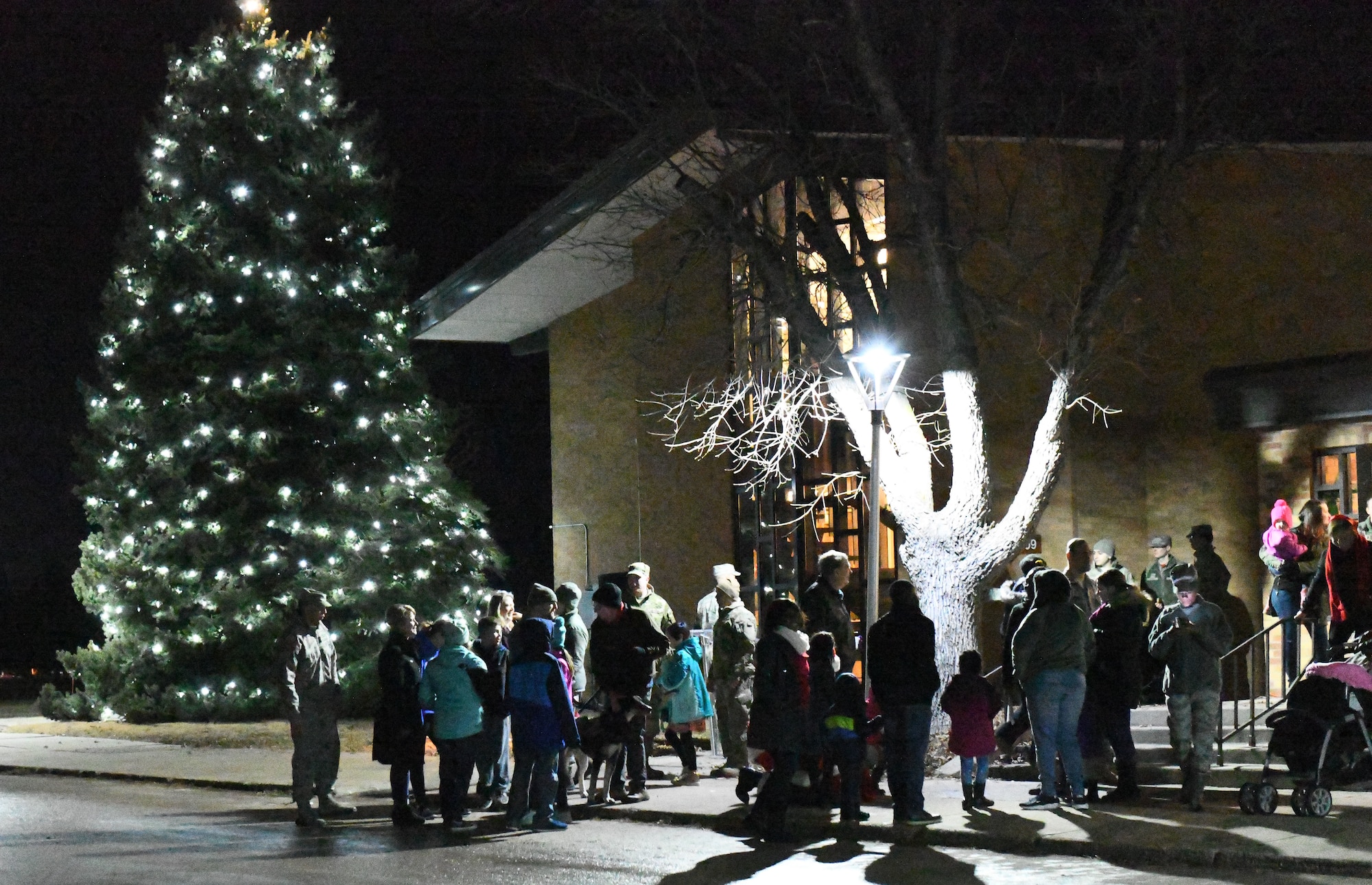 Members of the 28th Bomb Wing gather for a tree lighting ceremony at the Freedom Chapel on Ellsworth Air Force Base, S.D., Nov. 30, 2018. Airmen and their families came out to celebrate the lighting of the base tree and to start the holidays in a festive and family-friendly environment where multiple religions were represented. (U.S. Air Force photo by Airman 1st Class Thomas Karol)
