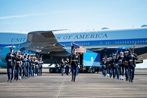 A military honor guard walks off after taking part in a departure ceremony honoring former President George H.W. Bush.