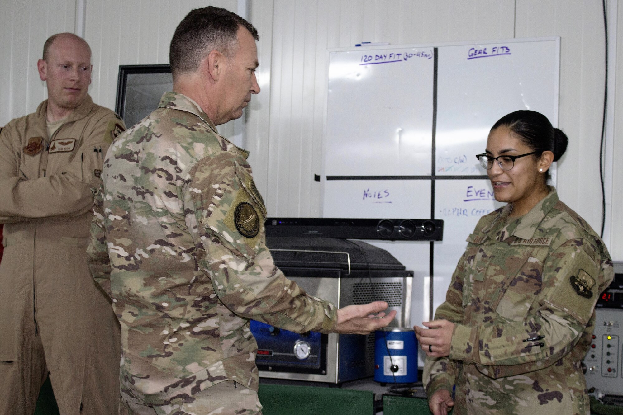 Maj. Gen. Chad Franks , Combined Joint Task Force-Operation Inherent Resolve deputy commander and 9th Air Expeditionary Task Force-Levant commander, presents a challenge coin to Airman 1st Class Desiree David, 391st Expeditionary Fighter Squadron aircrew flight equipment manager, Dec. 2, 2018.  Franks met with 332d Air Expeditionary Wing top performers to thank them for their hard work and perseverance in support of operations.  Commanders often present challenge coins in recognition of special achievement.  David is from Mountain Home Air Force Base, Idaho. (U.S. Air Force photo by Maj. John T. Stamm)