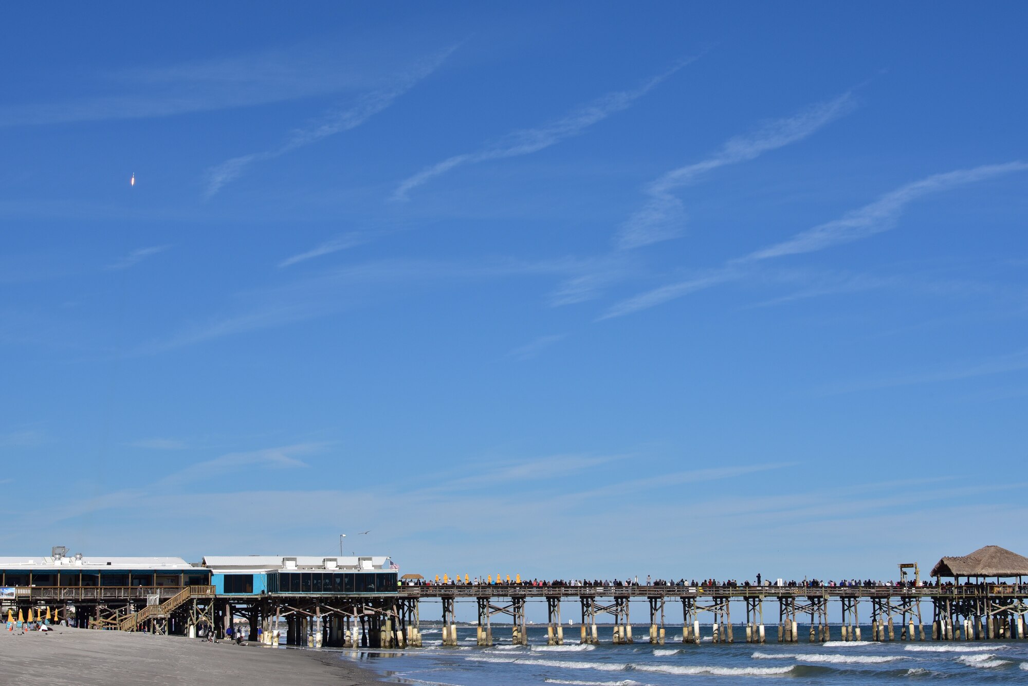 People watch SpaceX's Falcon 9 rocket CRS-16 liftsoff from Cape Canaveral Air Force Station, Space Launch Complex 40 on Dec 5, 2018 at Cocoa Beach, Fla. The CRS-16, a cargo resupply mission to the International Space Station, carried more than 5,600 pounds of supplies to the ISS, including 250 research and science projects. (U.S. Air Force photo by Tech. Sgt. Andrew Satran)