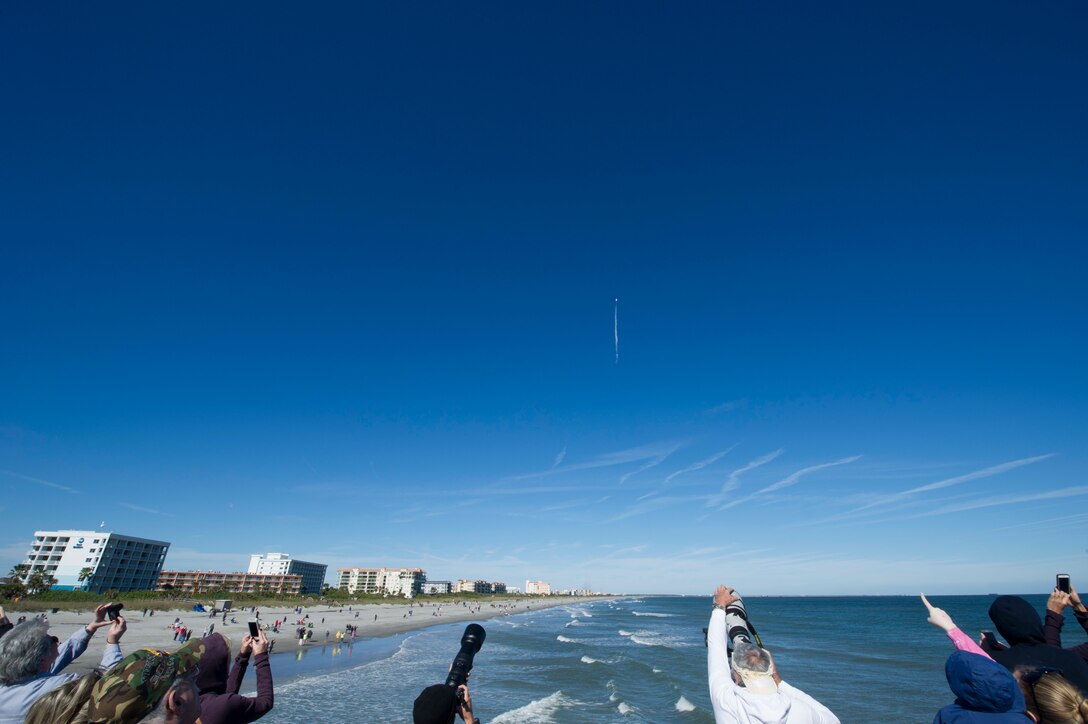 People watch SpaceX's Falcon 9 rocket CRS-16 lift off from Cape Canaveral Air Force Station, Space Launch Complex 40 on Dec 5, 2018 at Cocoa Beach, Fla. The CRS-16, a cargo resupply mission to the International Space Station, carried more than 5,600 pounds of supplies to the ISS, including 250 research and science projects. (U.S. Air Force photo by Airman 1st Class Dalton Williams)