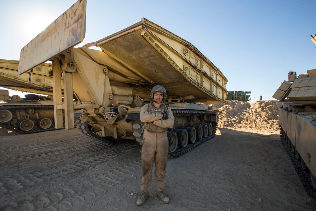 U.S. Marine Corps Cpl. Gerardo, Parra, an Assault Breacher Vehicle Joint Assault Bridge Operator, with 1st Combat Engineer Battalion, 1st Marine Division poses for a photo during exercise Steel Knight (SK) 2019 at Marine Corps Air Ground Combat Center, Twentynine Palms, California, Nov. 28, 2018