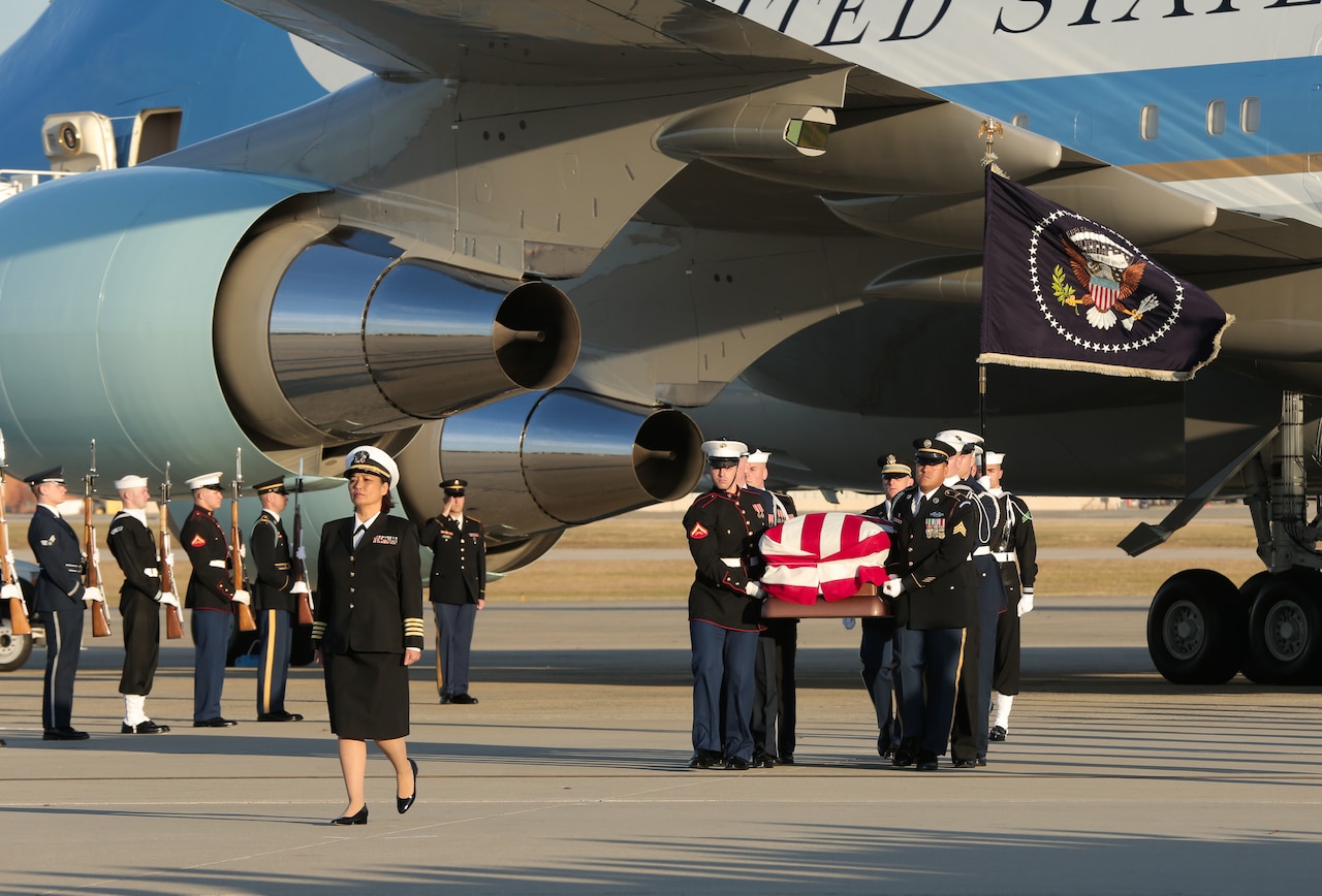 U.S. service members carry the casket of President George H.W. Bush at Joint Base Andrews, Maryland.