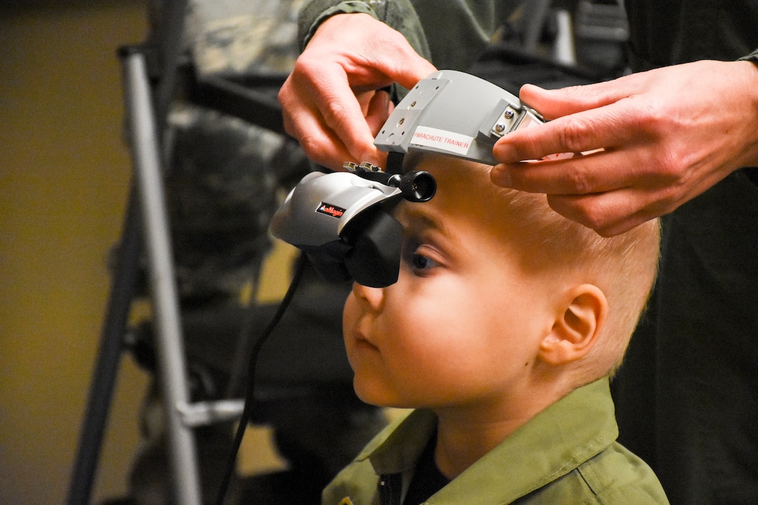 A child looks through the eyepiece on a piece of equipment.