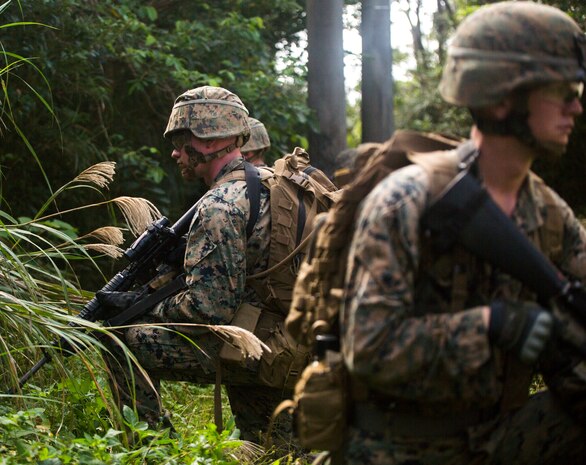Marines provide security during a patrol Dec. 4, 2018 at Jungle Warfare Training Center, Camp Gonsalves, Okinawa, Japan. Marines with 9th Engineer Support Battalion, 3rd Marine Logistics Group, took part in the Basic Jungle Skills Course which includes patrolling, repelling, land navigation and an endurance course. Jungle Warfare Training Center gives service members the opportunity to train in a jungle environment. (U.S. Marine Corps photo by Lance Cpl. Mark Fike)