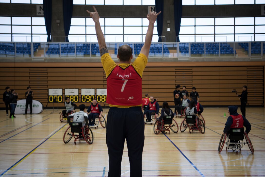 U.S. Navy Petty Officer 2nd Class Jason Noel, a Naval Air Facility-Misawa utilitiesman journeyman, throws up a “rock and roll” sign during the Misawa City Paralympics tribute game at the Misawa International Sports Center in Misawa City, Japan, Dec. 1, 2018. Kazumasa Taneichi, the Misawa City mayor, invited Misawa Air Base military members to participate in a Paralympic event in honor of the official Paralympics in Tokyo in 2020. (U.S. Air Force photo by Airman 1st Class Collette Brooks)