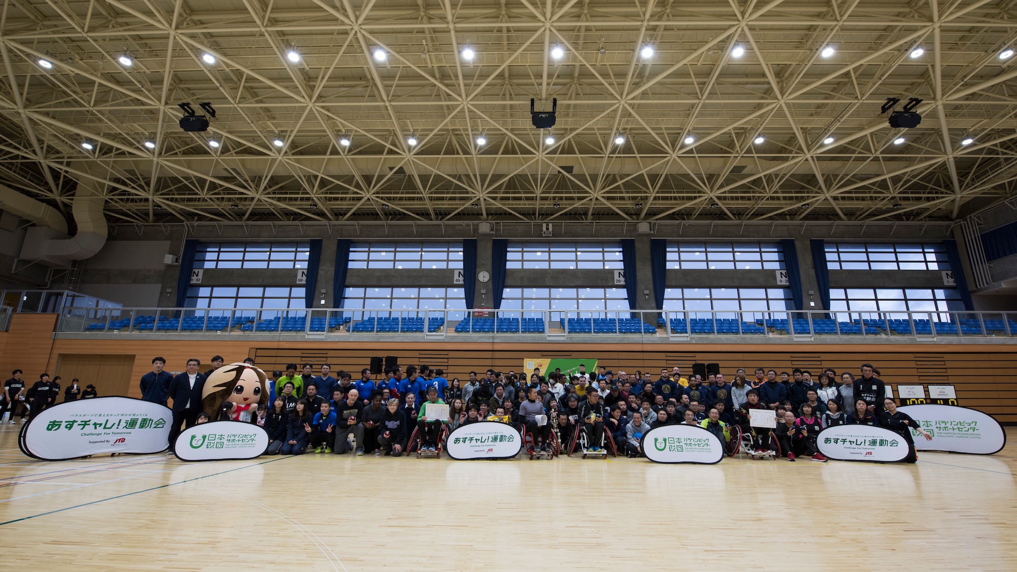 Paralympic attendees pose for a group photo during the Misawa City Paralympics tribute event at the Misawa International Sports Center in Misawa City, Japan, Dec. 1, 2018. In honor of the official Paralympics taking place in Tokyo, in 2020, city officials worked with the Nippon Paralympics committee to bring a modified version to the Misawa community. (U.S. Air Force photo by Airman 1st Class Collette Brooks)